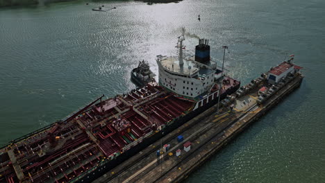 panama city aerial v35 cinematic low birds eye view drone fly around cargo tanker ship at miraflores lake transiting at canal locks towards the pacific ocean - shot with mavic 3 cine - march 2022