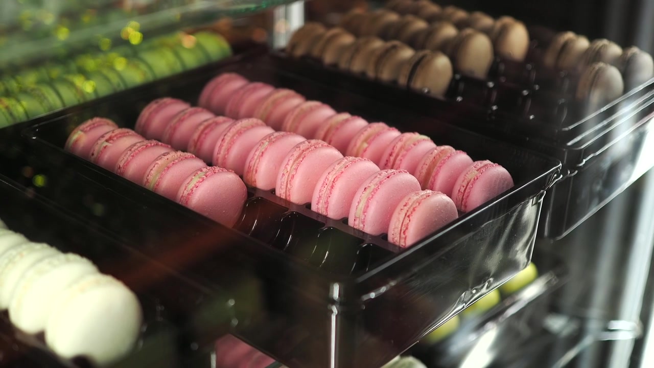 Rows of Pink Macarons Displayed in a Bakery Shop Window