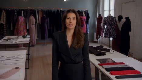 woman in fashion studio with clothing racks