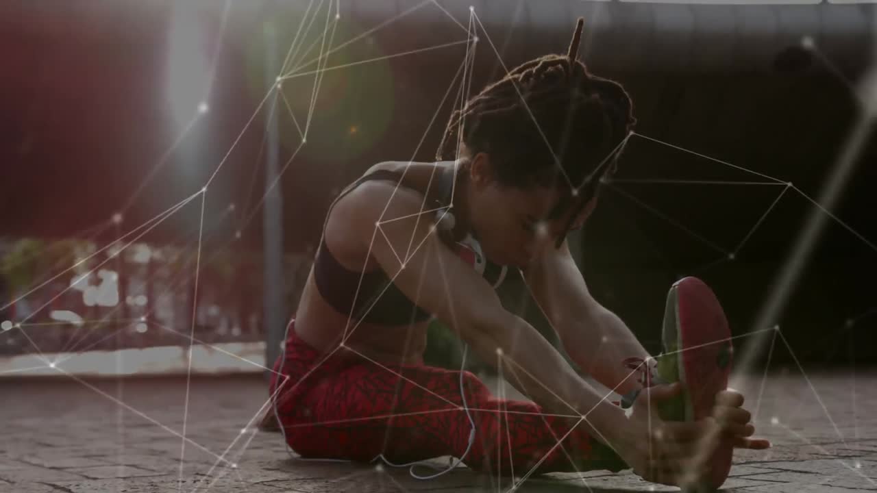 red de conexiones contra una mujer afroamericana que realiza ejercicios de estiramiento en el parque