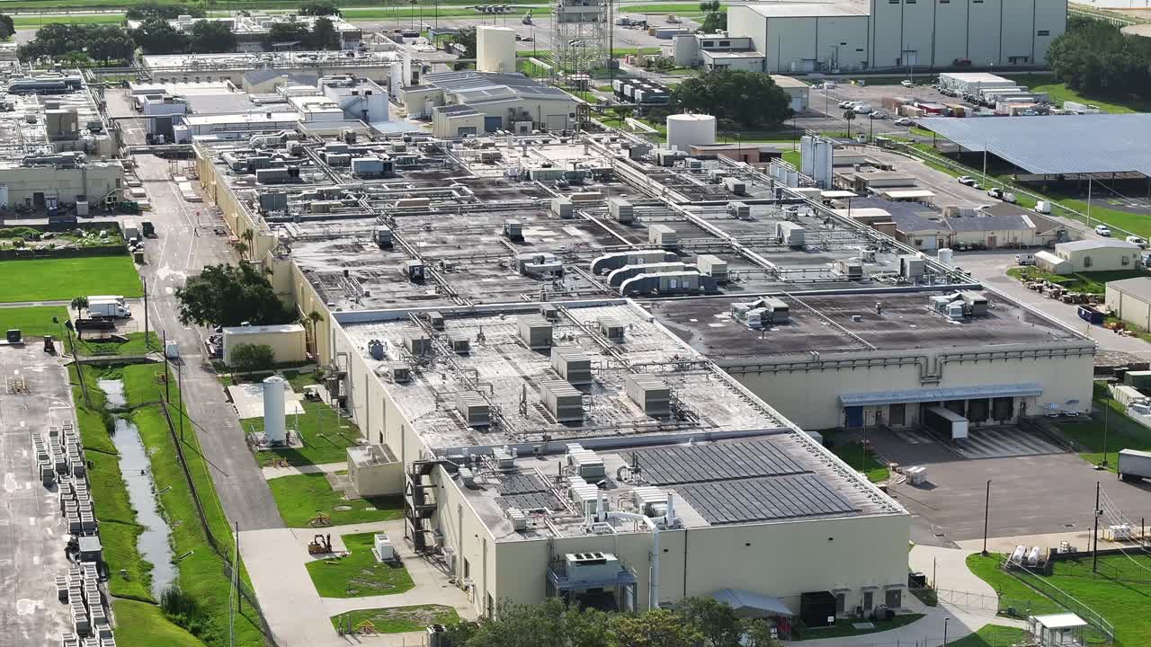 Aerial view showing industrial roof with pipelines and and air conditioner of warehouse in USA.