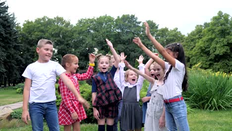 kids team building. a group of happy children holding hands together. team outdoor in park