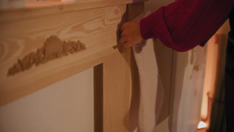 Woman-hanging-stocking-on-table-at-home