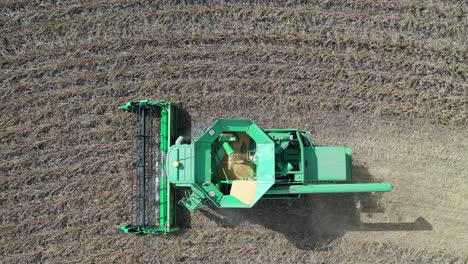 combine harvester harvesting soybeans from aerial view