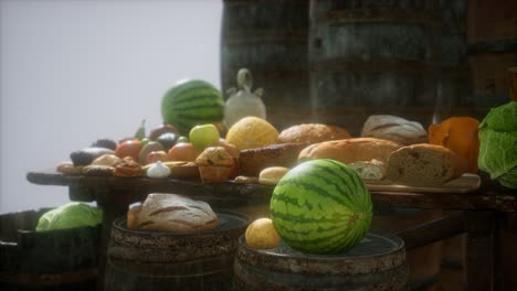 food table with wine barrels and some fruits, vegetables and bread