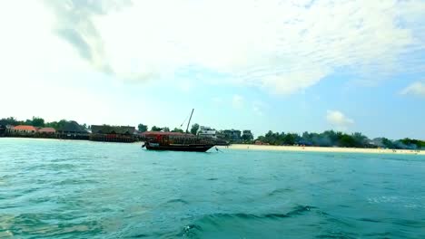 local-wooden-fishing-boat-with-sail-at-zanzibar-beach-tanzania