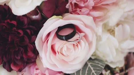 roses up close with a macro lens and wedding rings posed on the petals