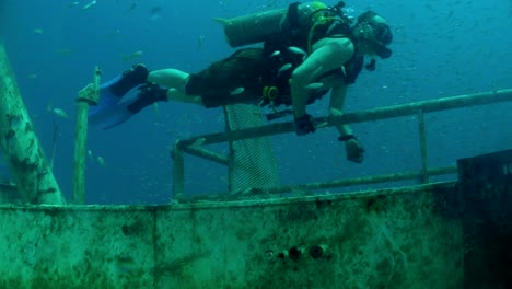 divers explore a shipwreck