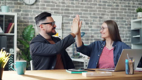 happy colleagues high-fiving
