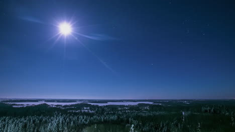 moon and stars over a winter landscape wilderness - nighttime time lapse