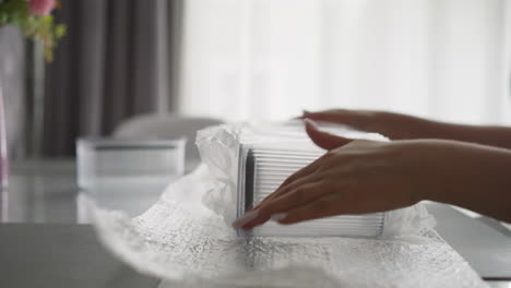 female hands unpack new plastic containers package in kitchen