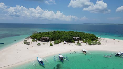 aerial panoramic overview of patawan island and banca boats on shoreline