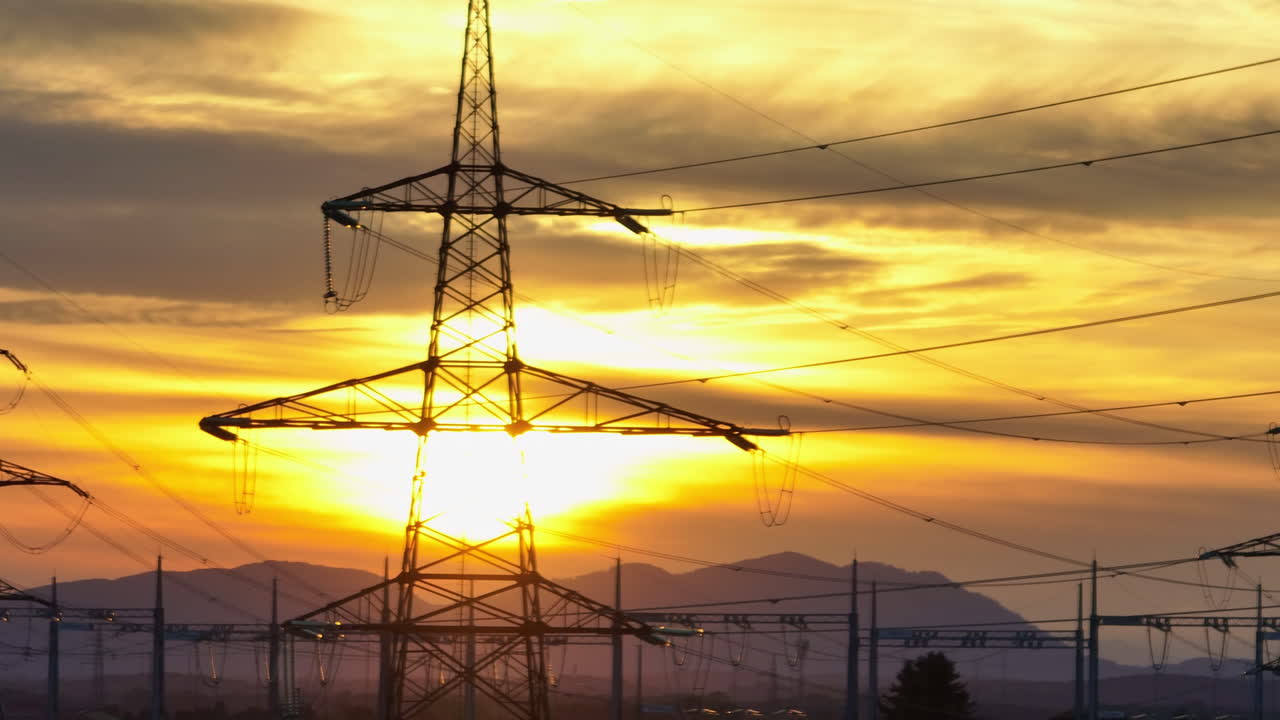 Crane of highvoltage electrical substation switchyard shows transformers and transmission lines