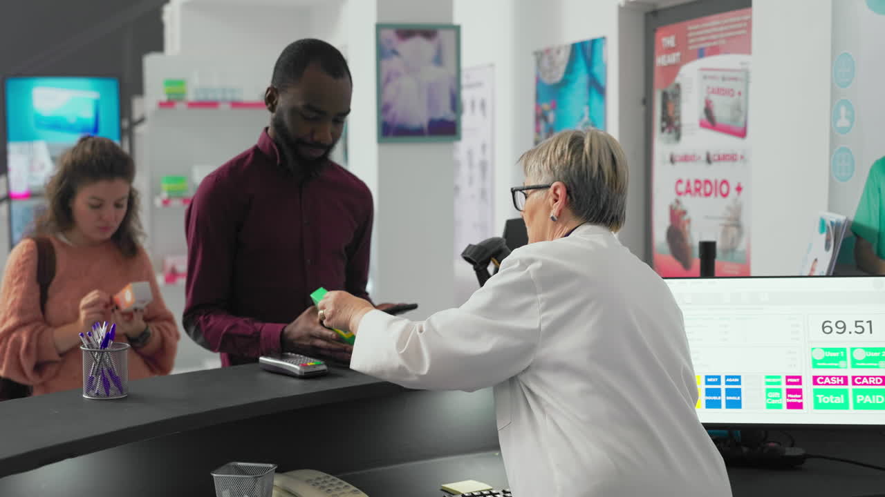 Customers making payments at a pharmacy counter
