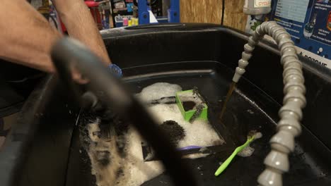 rear dérailleur is washed in a cleaning bath