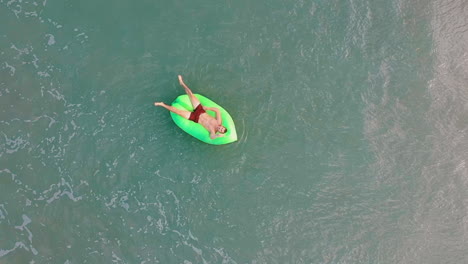 man relaxing in turqoise water in the philippines on vacation