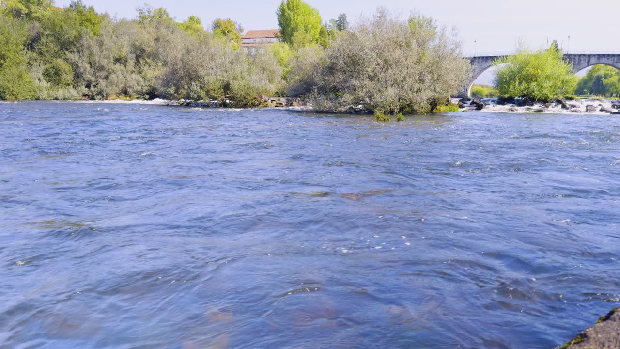 Close up of the water flowing strong in the Lima river at Ponte da Barca