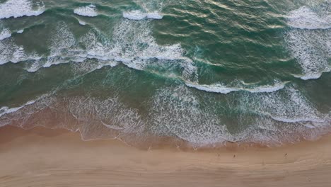 Early-morning-jogging-along-Surfers-Paradise-beach-with-wave-rolling-in