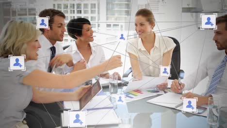 animation of networks of people icons over business people in meeting in office