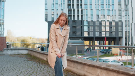 sick sad mature businesswoman suffer from painful discomfort severe knee joint ache on city street