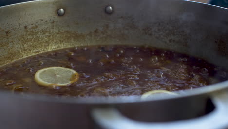 limón amarillo fresco en rodajas que se coloca en salsa de curry a fuego lento y se agita-1