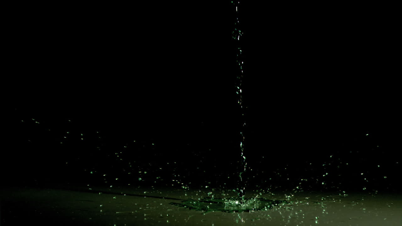 Liquid dripping in super slow motion on water surface
