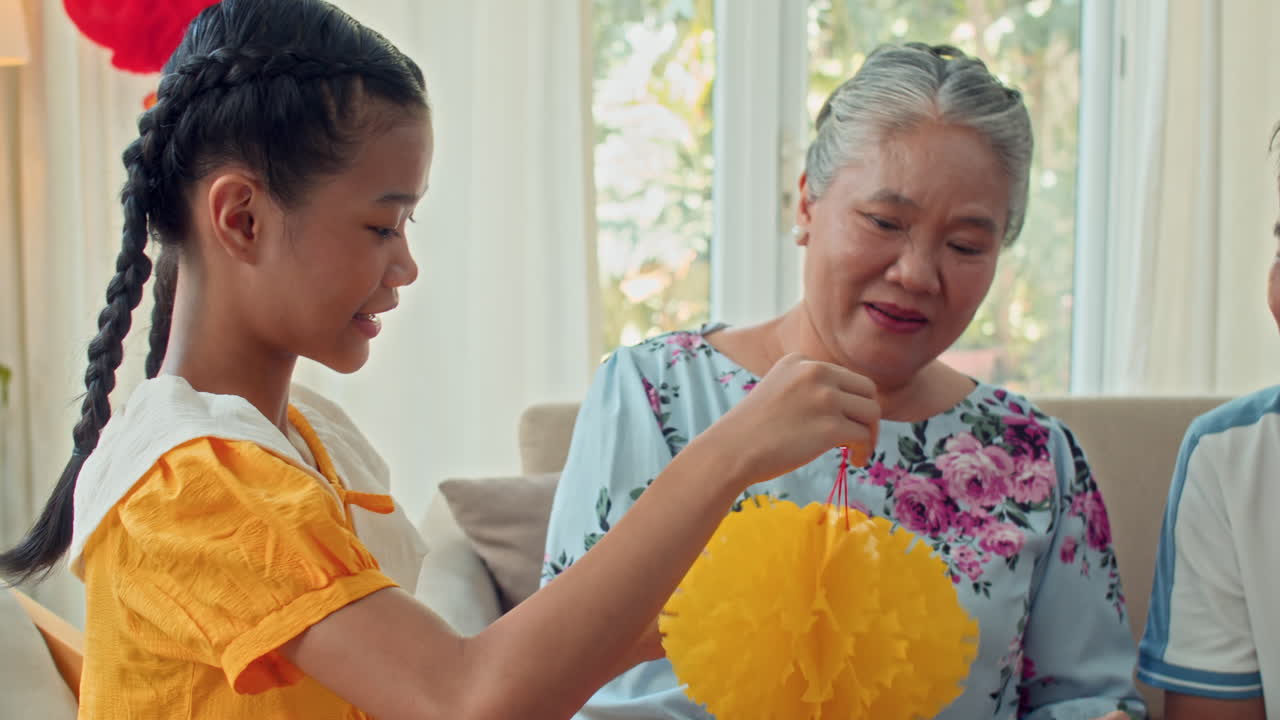 Vietnamese Family Creating Paper Decorations for Lunar New Year