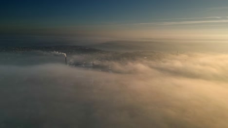 Aerial-Drone-scene-above-the-Urban-townscape-landscape,-areas-shrouded-In-thick-morning-mist