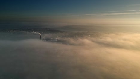 aerial drone scene above the urban townscape landscape, areas shrouded in thick morning mist