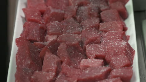 seasoning properly diced stewing beef with sea salt and dried garlic