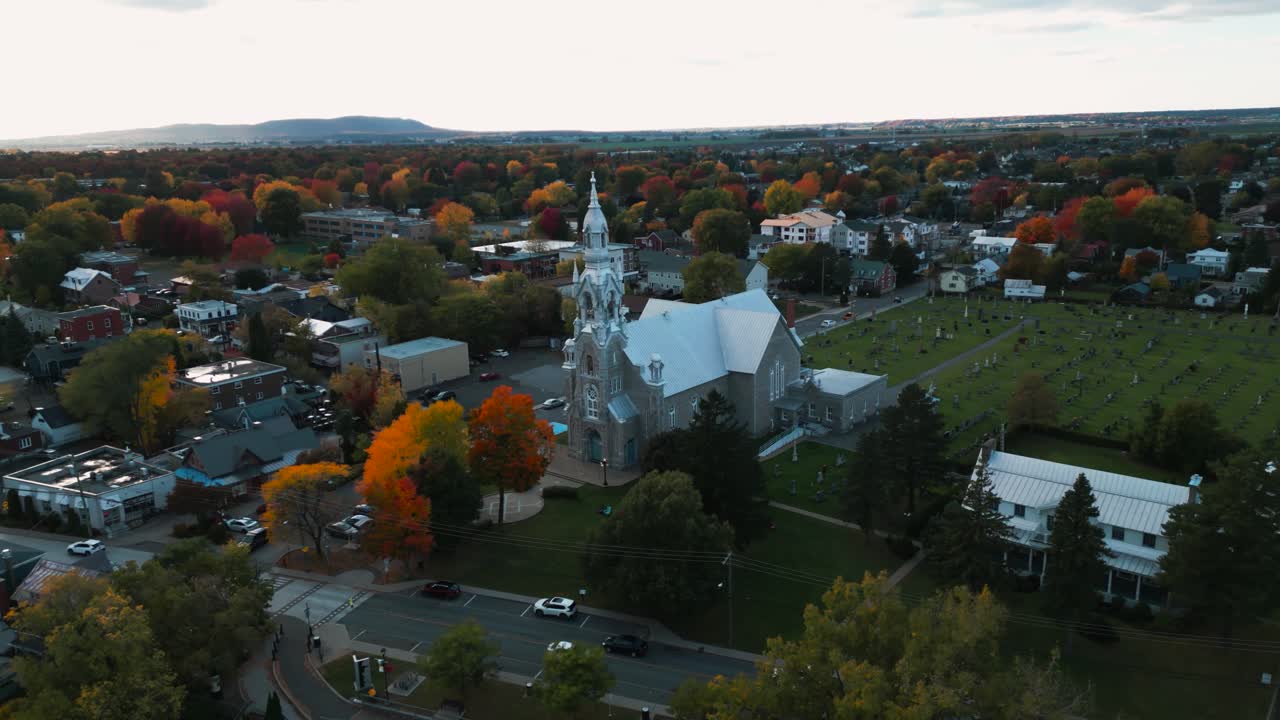aerial circular shot around St Matthieu Church in Beloeil, montreal area in Quebec province during fall season in Canada