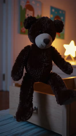 a teddy bear in a child's room at night