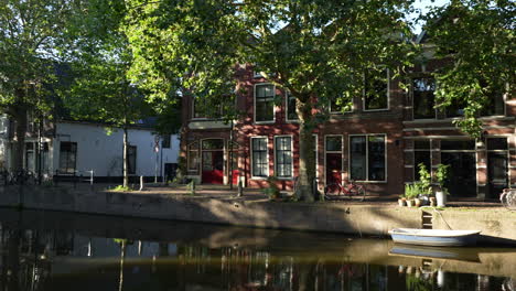 Panning-Reveal-Of-Typical-Dutch-House-By-The-Canal-In-Netherlands