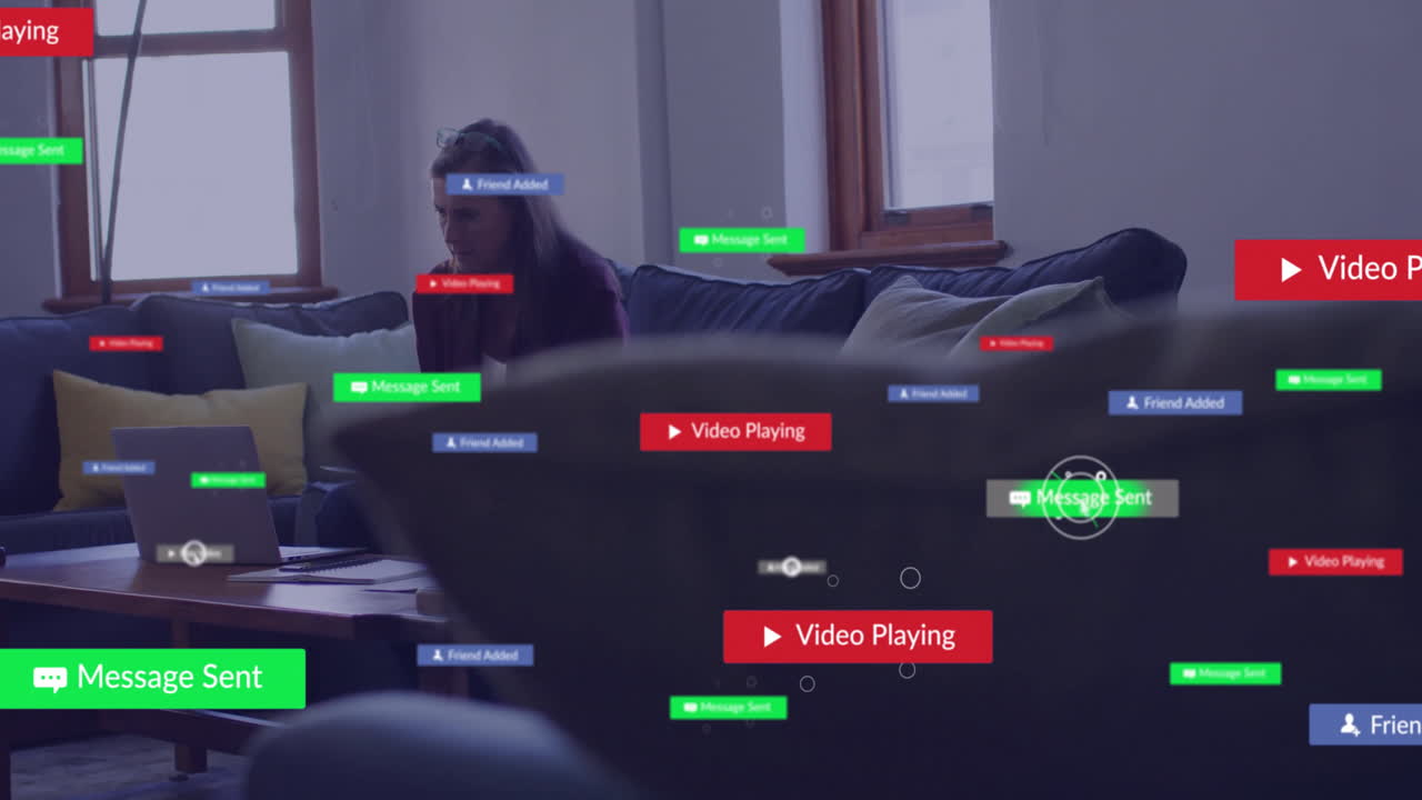 Using laptop on couch, woman focused on animation of social media notifications