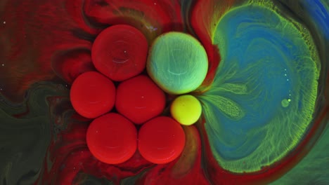 colorful bubbles. abstract red, yellow, blue, green mixture on a black background. artistic color paint background.