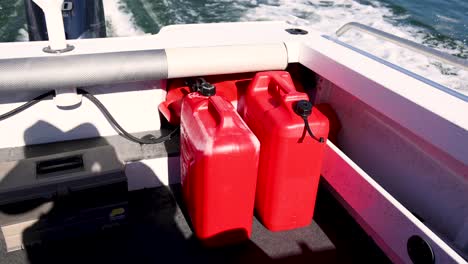 red fuel containers on a moving boat