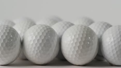primer plano de las pelotas de golf sobre un fondo blanco, espacio de copia, cámara lenta
