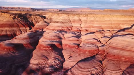 Aerial-View-of-Picturesque-Layered-Sandstone-Hills-in-Utah-Desert,-Another-Planet-Relief-Resemble-on-Golden-Hour-Sunlight