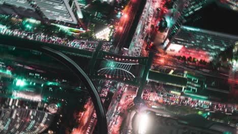 time-lapse or hyper-lapse zoom out : aerial view 4 way road stop circle or intersection traffic at night for transportation concept.