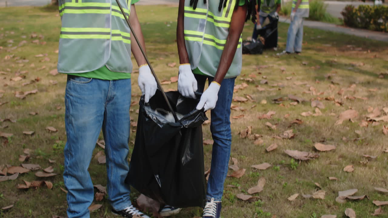 Portrait of Biracial Couple Cleaning Trash from City Park