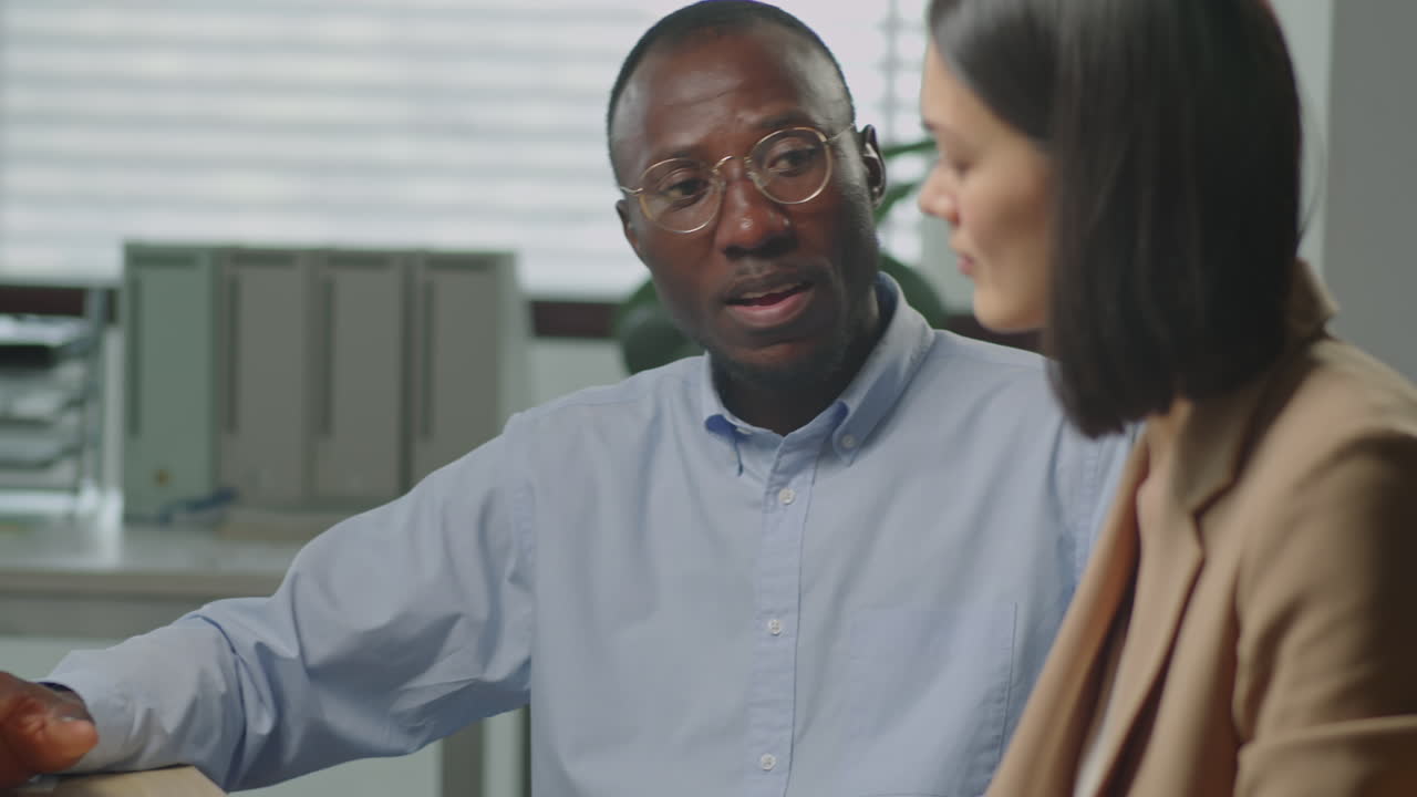 Black Businessman Having Conversation with Colleague in Office