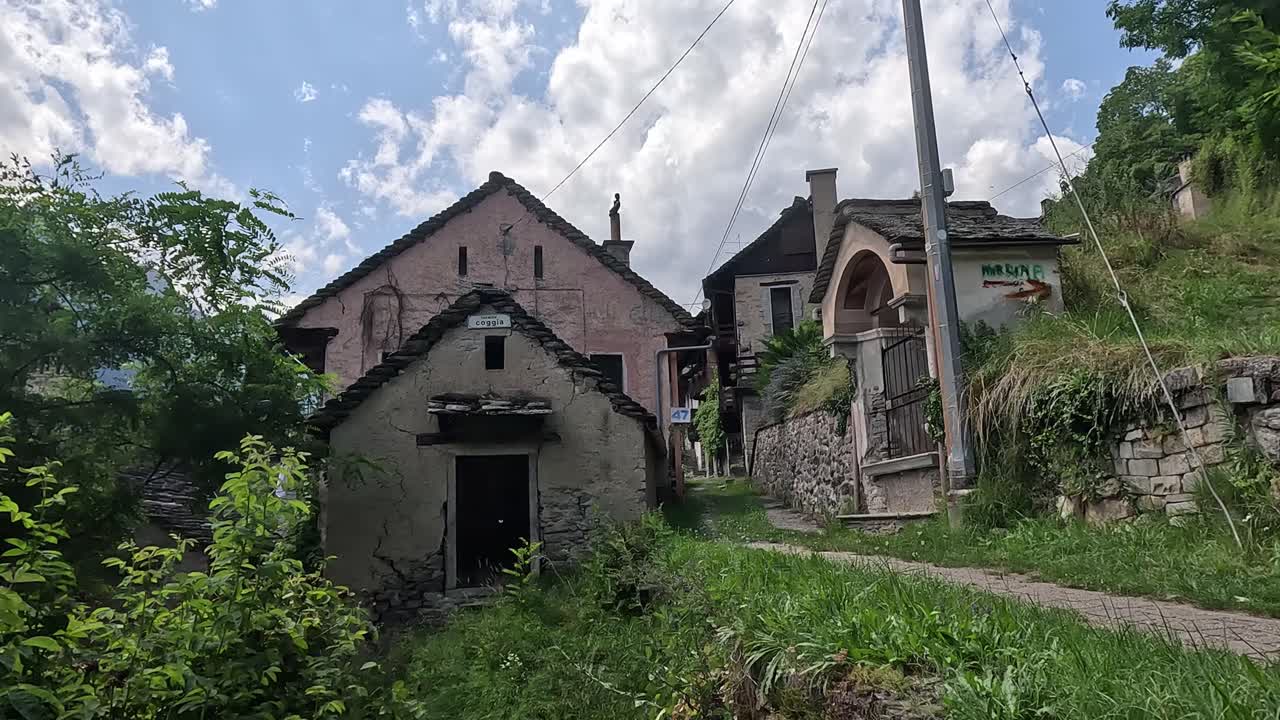 Historic Stone Houses and Chapel in the Mountain Village of Varzo, Piedmont, Italy on a Sunny Day