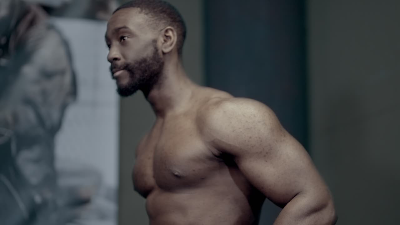 Strong African American man resting between dip sets