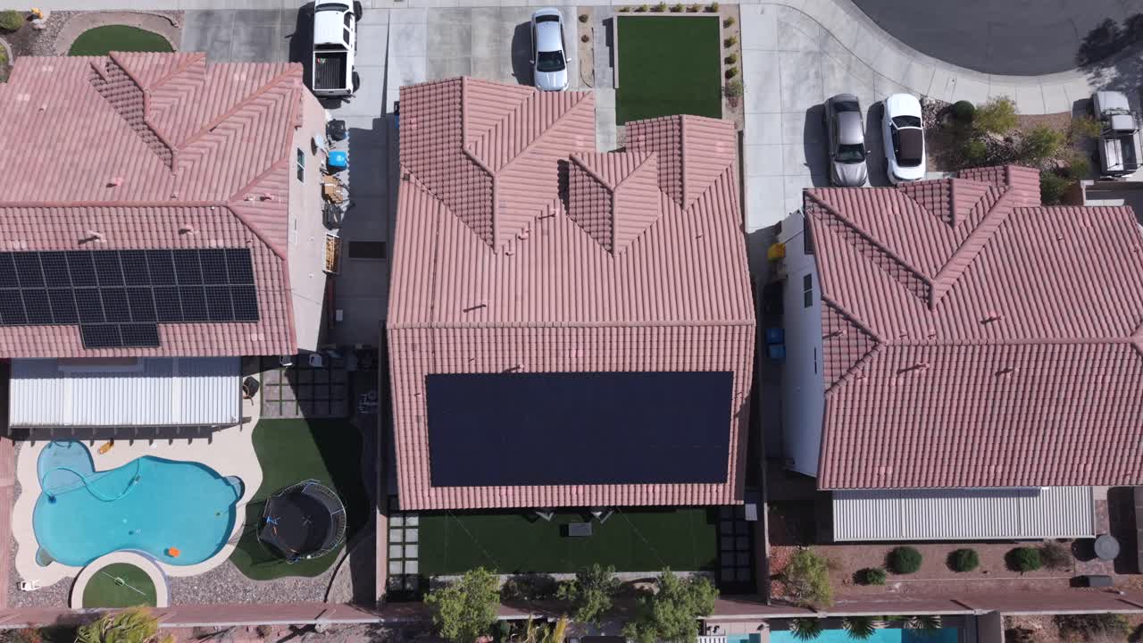 Solar Panels On The Rooftops Of Houses In A Residential Neighborhood Aerial energy Shot