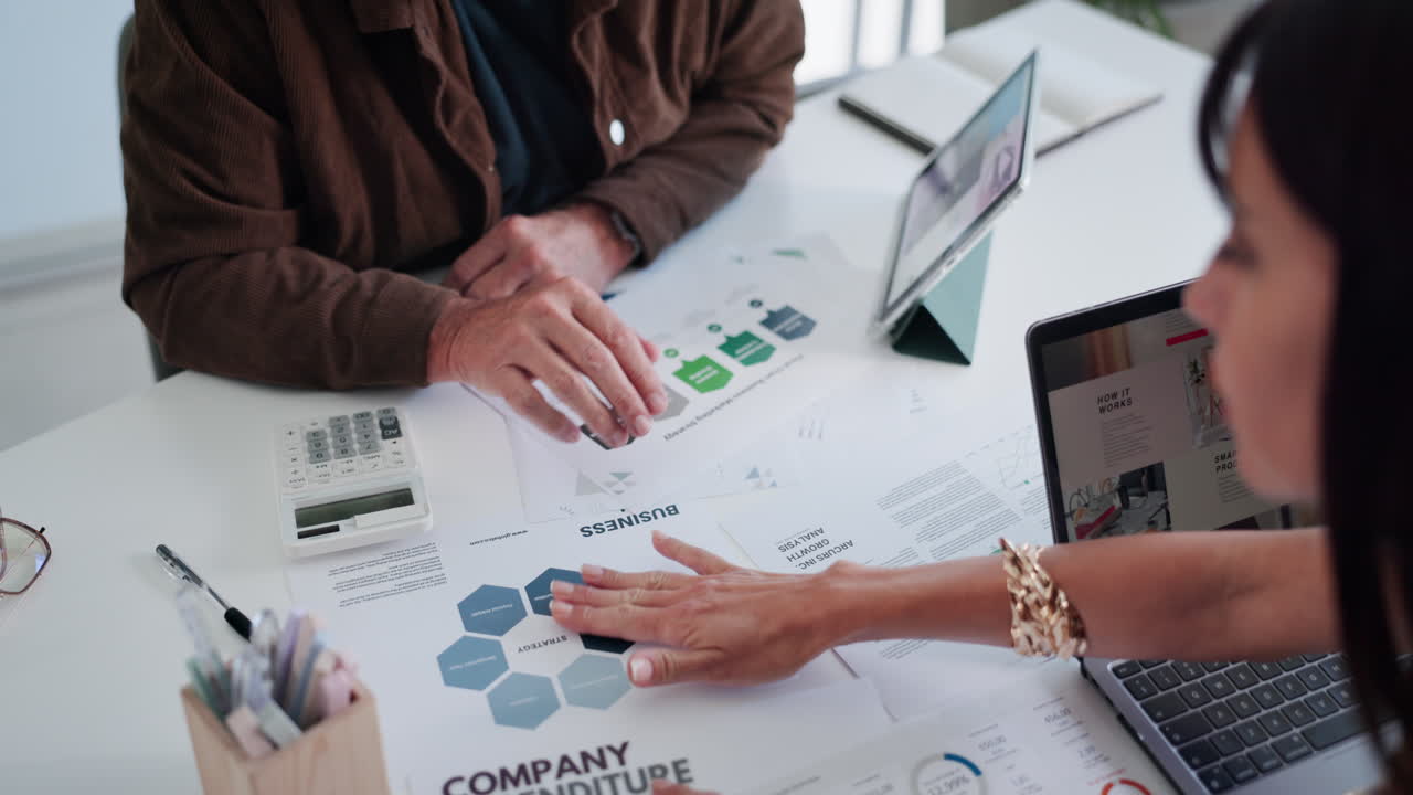 Business Professionals Analyzing Financial Reports and Charts