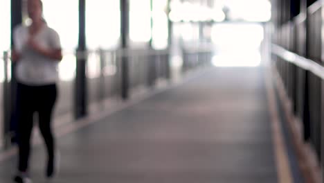 individual running towards camera in a bright hallway