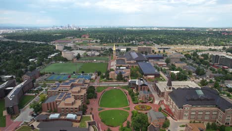 aerial drone flyover of university of denver college campus with city and neighborhood in the background - denver , colorado, usa