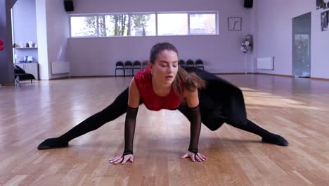 slow motion female dancer spinning and does a split