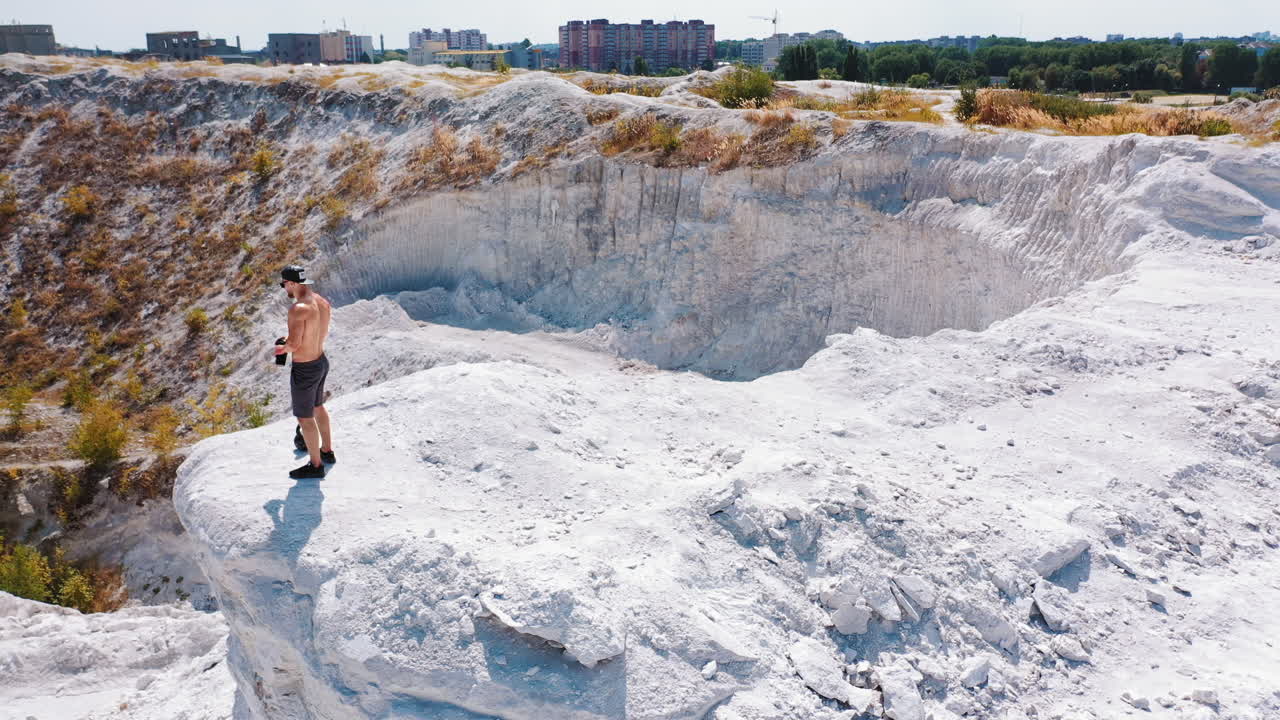 Professional bodybuilder posing outdoors. Concept of beautiful healthy body. Aerial view