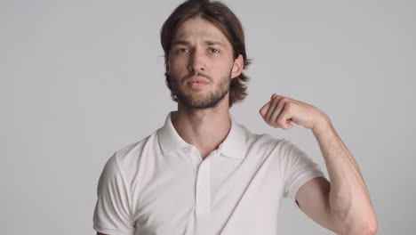 caucasian man in front of camera on gray background.